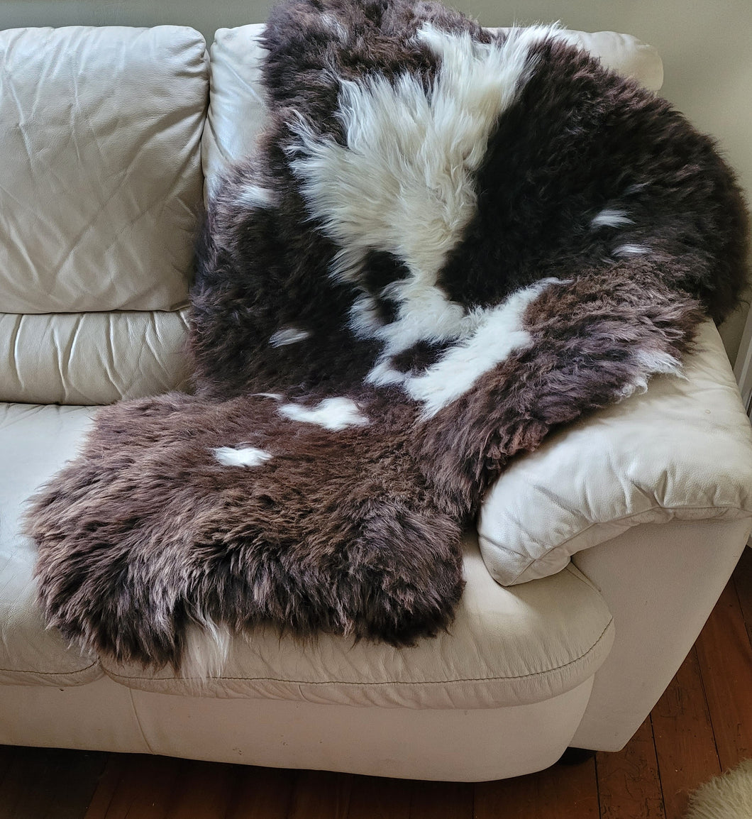 Naturally beautiful - undyed sheepskin rug.  Extra large dark brown/white. 120cm