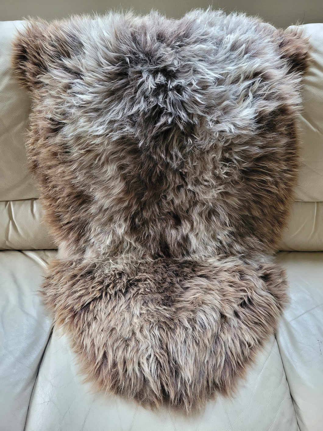 Naturally beautiful - undyed sheepskin rug. Shades of golden brown/tan/ivory 95cm